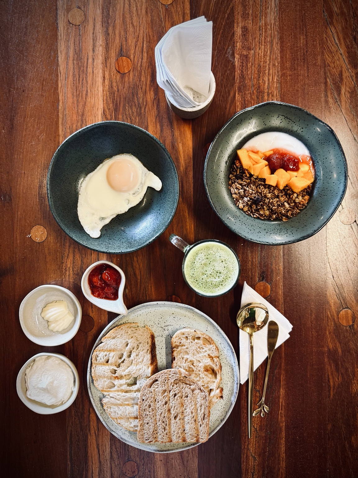 Breakfast at Amata with bread, spreads, granola, fruit and matcha